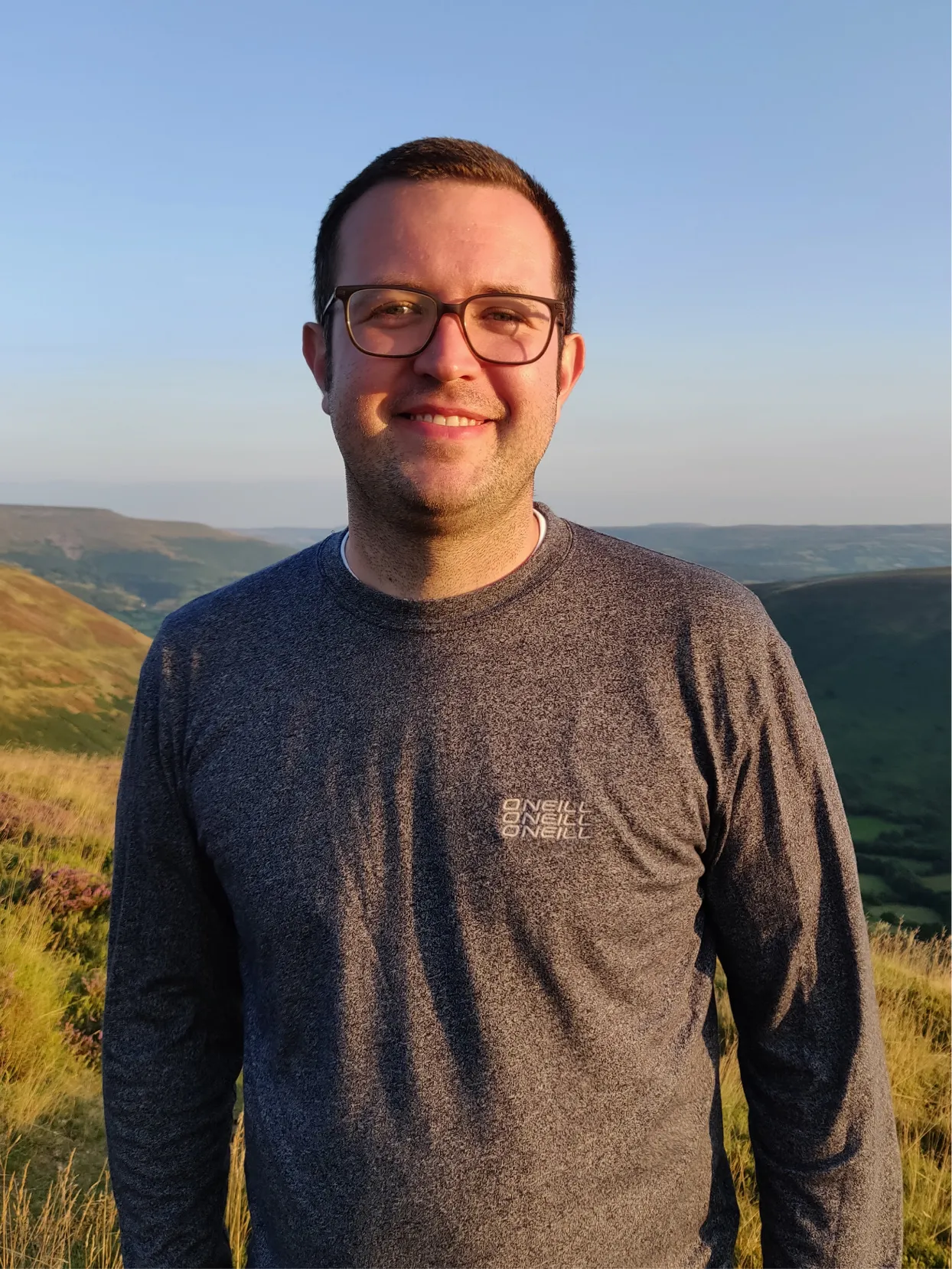 Jozsef Szabics smiling outdoors on a hillside
